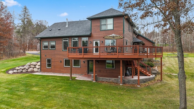 rear view of house with a yard, a patio, and a deck