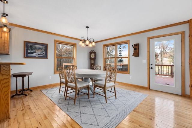 dining space featuring a wealth of natural light, light hardwood / wood-style floors, and ornamental molding