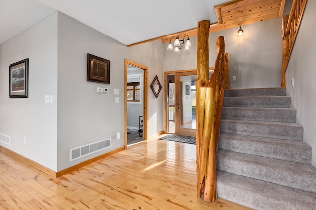 entryway featuring hardwood / wood-style floors and an inviting chandelier