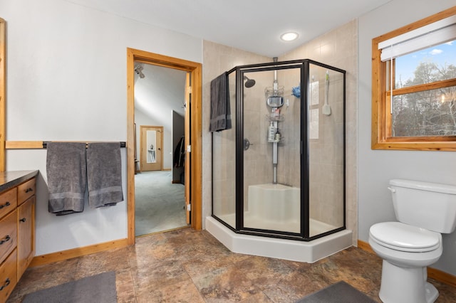 bathroom with vanity, toilet, and walk in shower