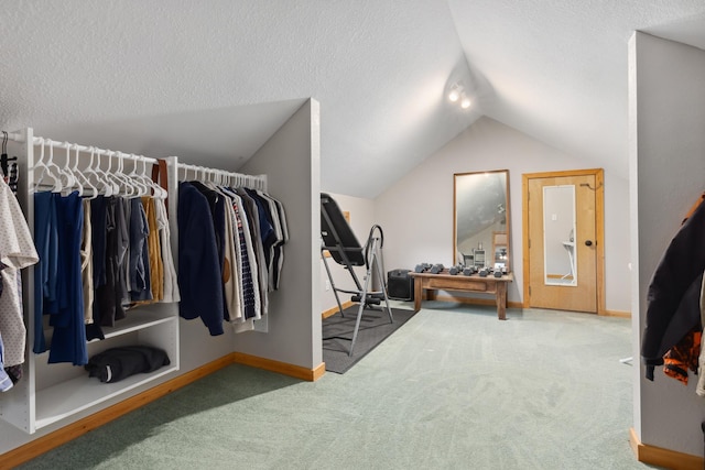 walk in closet with carpet flooring and lofted ceiling