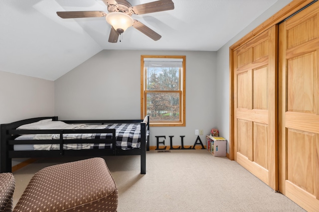 bedroom with ceiling fan, light colored carpet, and vaulted ceiling