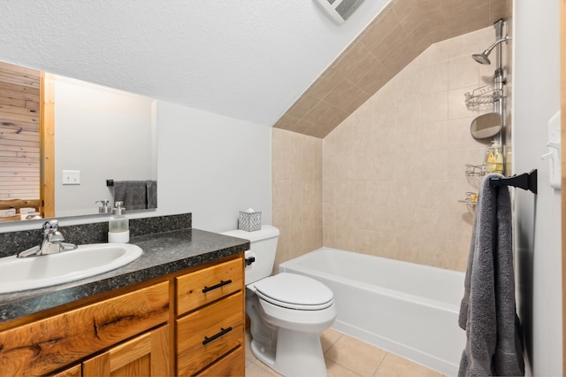 full bathroom featuring toilet, vanity, tile patterned floors, and tiled shower / bath combo