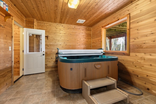 misc room featuring a jacuzzi, wood ceiling, and wood walls