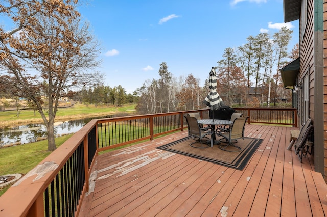 wooden terrace featuring a water view