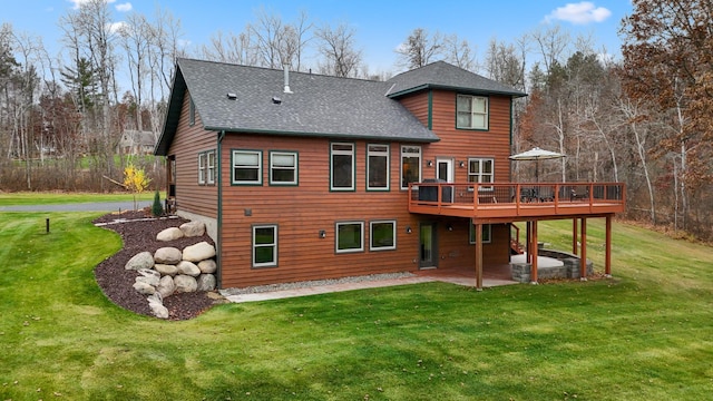 back of property featuring a yard, a patio area, and a wooden deck