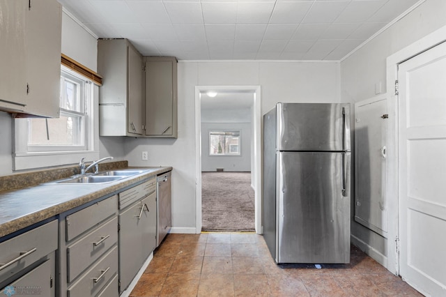 kitchen featuring gray cabinetry, sink, light carpet, appliances with stainless steel finishes, and ornamental molding