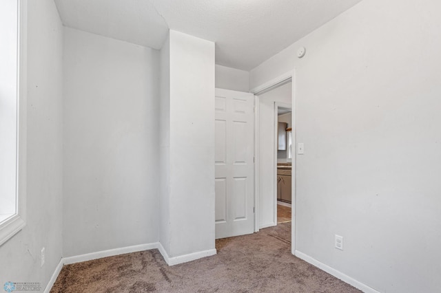 empty room featuring light colored carpet