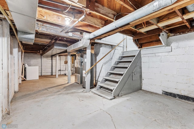 basement featuring washer / clothes dryer and heating unit