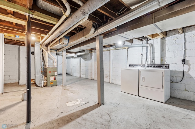 basement with heating unit and washer and clothes dryer