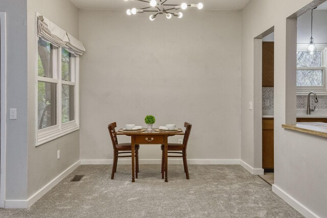 7037 110th Street Cir Unit 14, Bloomington, MN 55438 - dining area with a chandelier, light colored carpet, and baseboards