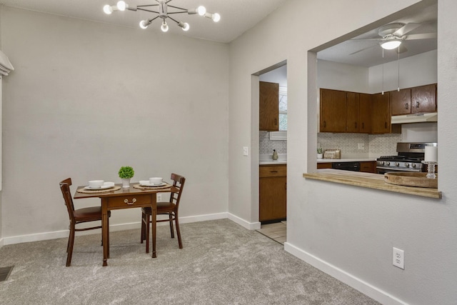 7037 110th Street Cir Unit 14, Bloomington, MN 55438 - dining area with light carpet, baseboards, a ceiling fan, and a chandelier