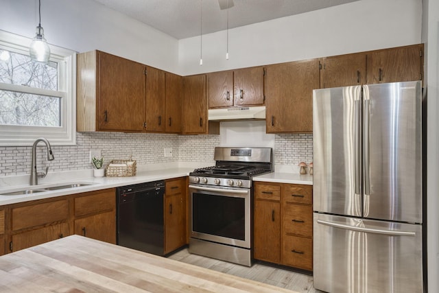 7037 110th Street Cir Unit 14, Bloomington, MN 55438 - kitchen with stainless steel appliances, under cabinet range hood, a sink, light countertops, and brown cabinets