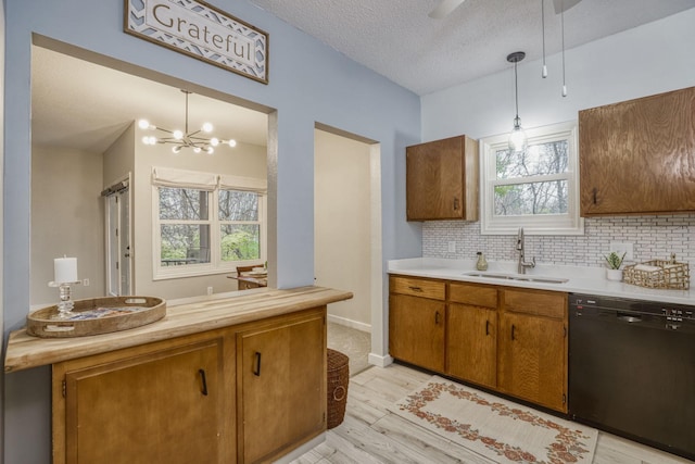 7037 110th Street Cir Unit 14, Bloomington, MN 55438 - kitchen with black dishwasher, a sink, light wood-type flooring, light countertops, and brown cabinets