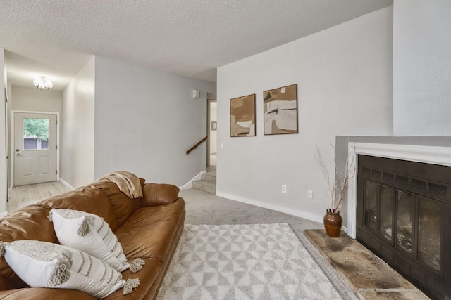 7037 110th Street Cir Unit 14, Bloomington, MN 55438 - living room with a glass covered fireplace, stairs, baseboards, a textured ceiling, and light colored carpet