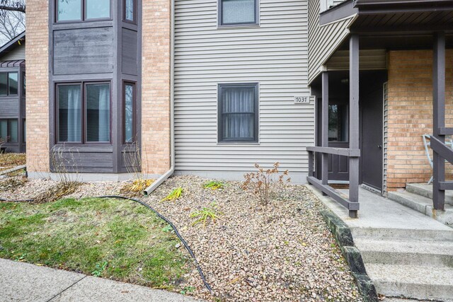 7037 110th Street Cir Unit 14, Bloomington, MN 55438 - view of home's exterior featuring brick siding
