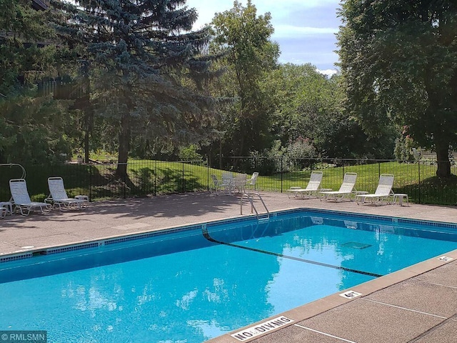 7037 110th Street Cir Unit 14, Bloomington, MN 55438 - community pool featuring a patio and view of scattered trees