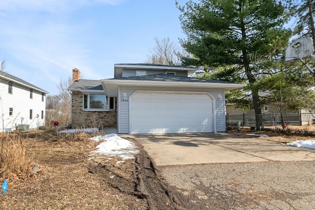 view of front of property featuring brick siding, fence, concrete driveway, a chimney, and a garage