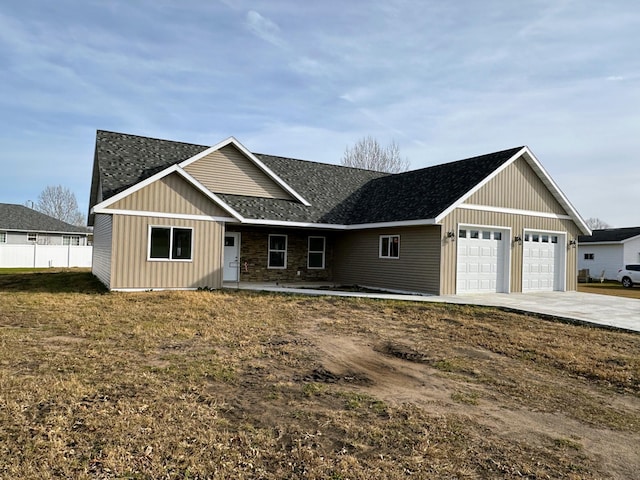 single story home featuring a front lawn and a garage