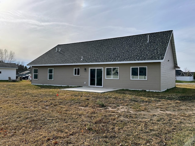 back of property featuring a lawn and a patio