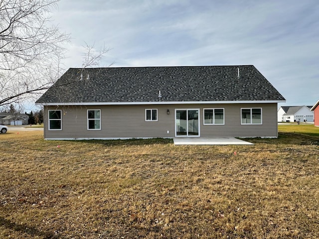 rear view of property with a yard and a patio