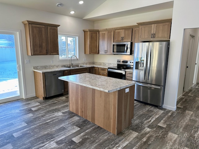 kitchen featuring stainless steel appliances, a kitchen island, dark hardwood / wood-style floors, and sink