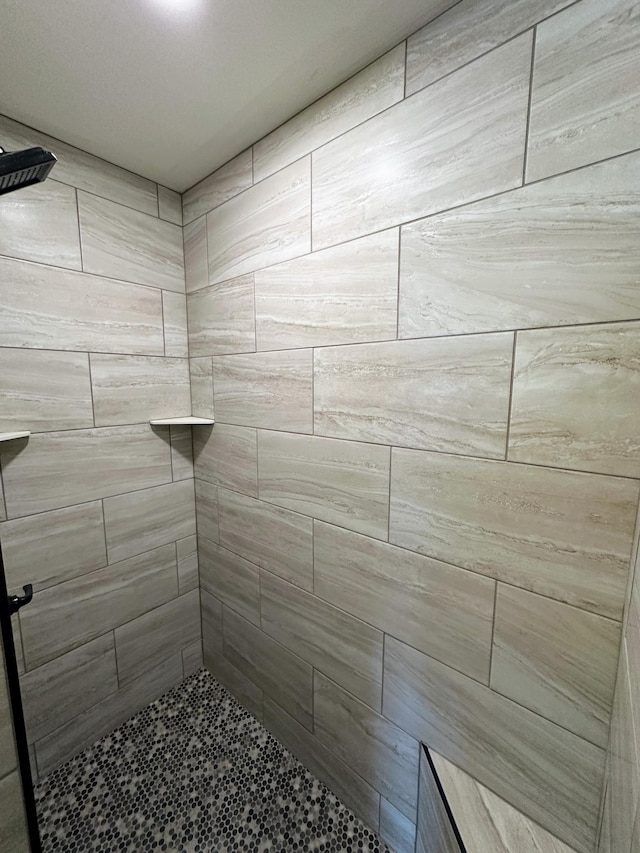 bathroom with tiled shower