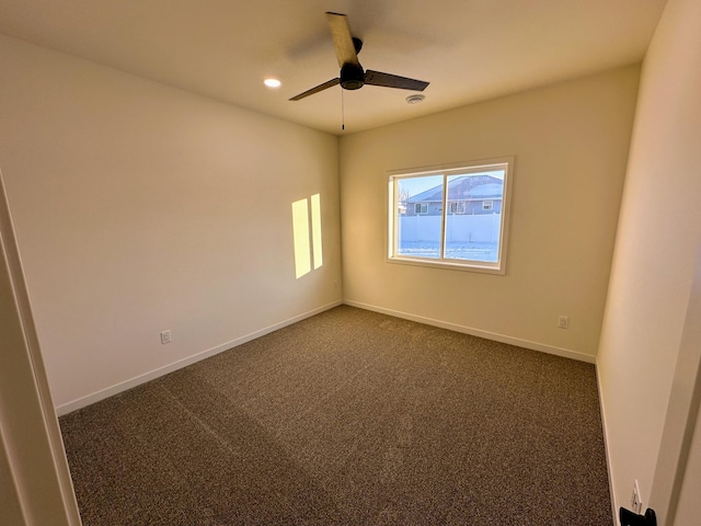 carpeted spare room with ceiling fan