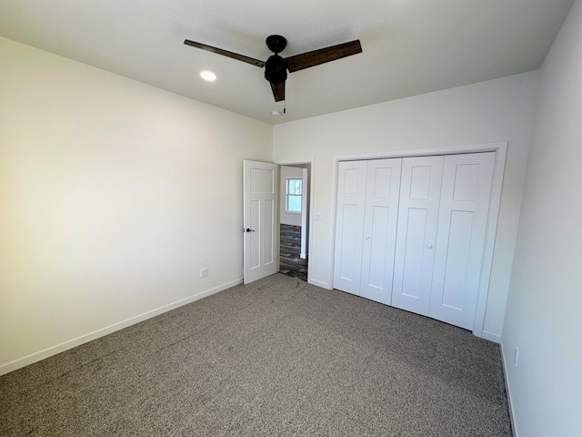 unfurnished bedroom featuring ceiling fan, a closet, and carpet floors