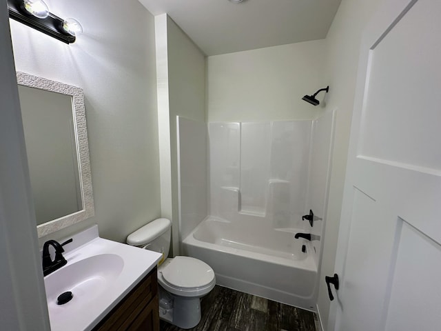 full bathroom featuring toilet, vanity,  shower combination, and hardwood / wood-style flooring