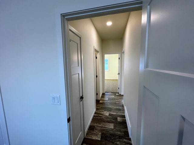 corridor with dark hardwood / wood-style flooring