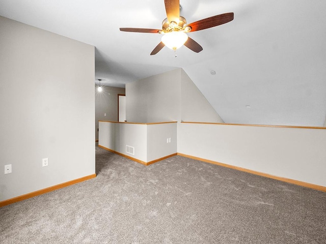 unfurnished room featuring ceiling fan, carpet flooring, and lofted ceiling