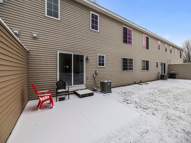 snow covered property featuring central air condition unit