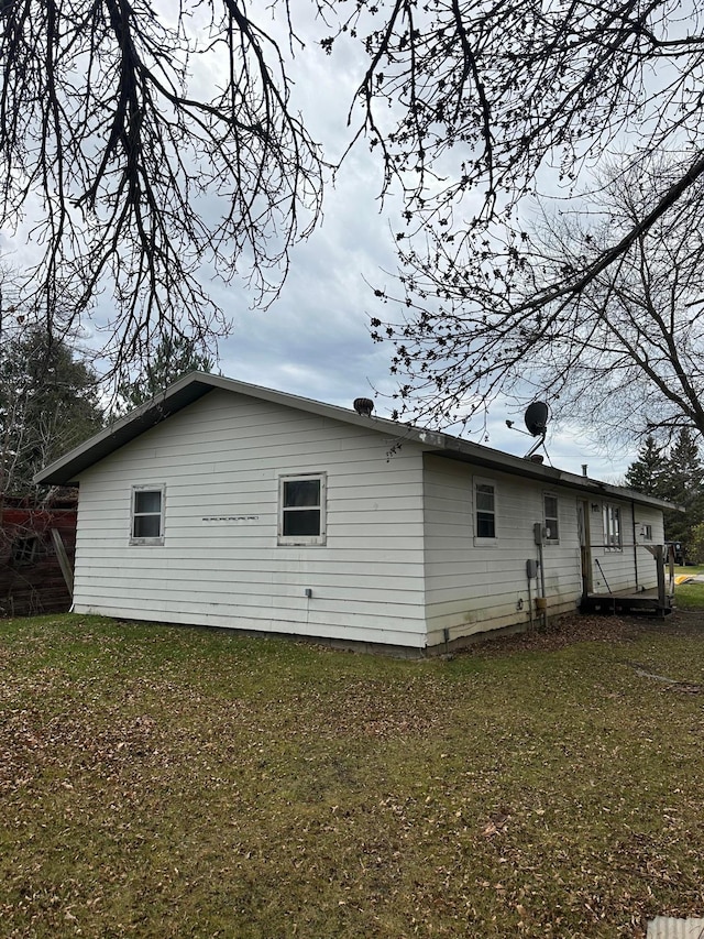 rear view of property featuring a yard