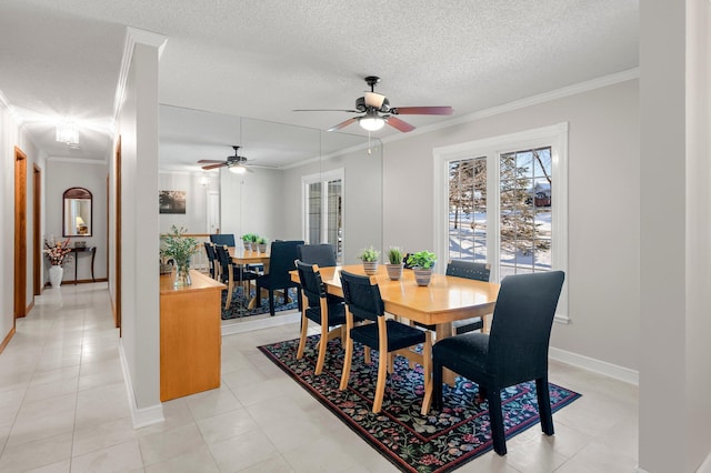 dining room with ceiling fan, crown molding, light tile patterned flooring, and a textured ceiling