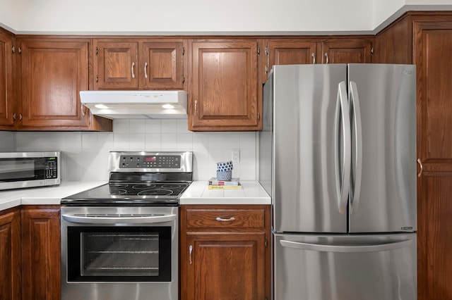 kitchen featuring stainless steel appliances and decorative backsplash