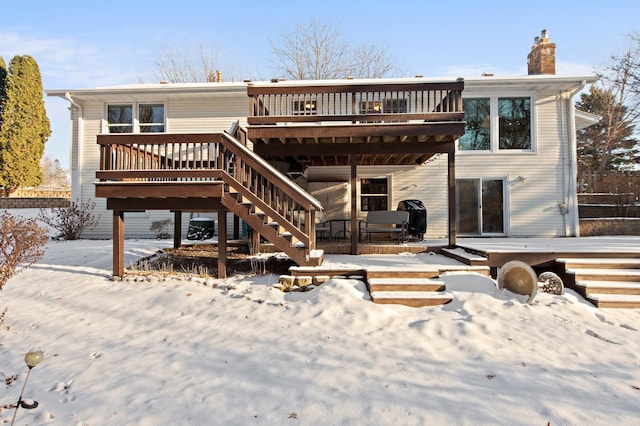 snow covered property featuring a wooden deck