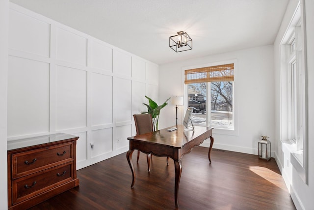 home office with baseboards, dark wood finished floors, and a decorative wall