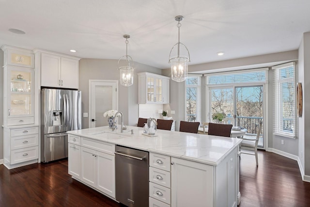 kitchen featuring white cabinets, dark wood-style flooring, appliances with stainless steel finishes, and a sink