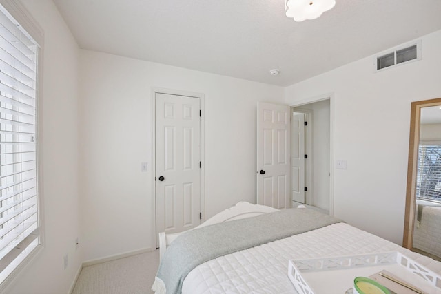 bedroom with visible vents, baseboards, and carpet floors