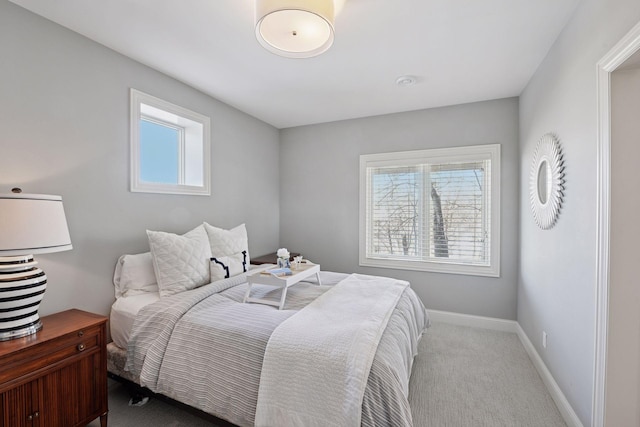 bedroom with carpet flooring, multiple windows, and baseboards