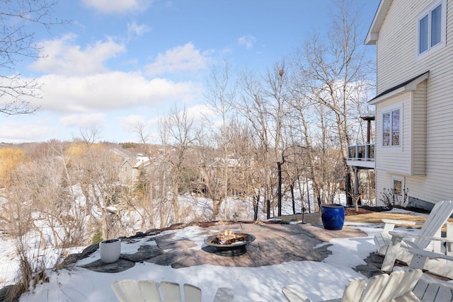 view of yard featuring a fire pit and a balcony