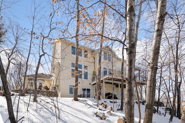 snow covered property with a garage