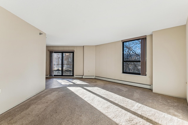 carpeted empty room with baseboard heating