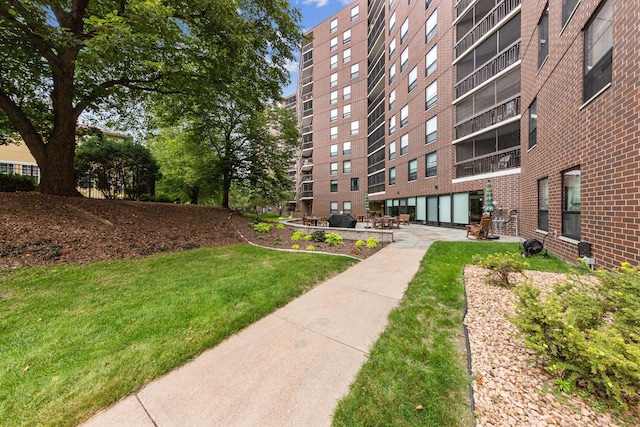 surrounding community featuring a lawn and a patio area