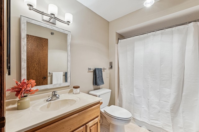 bathroom featuring vanity, a shower with shower curtain, and toilet