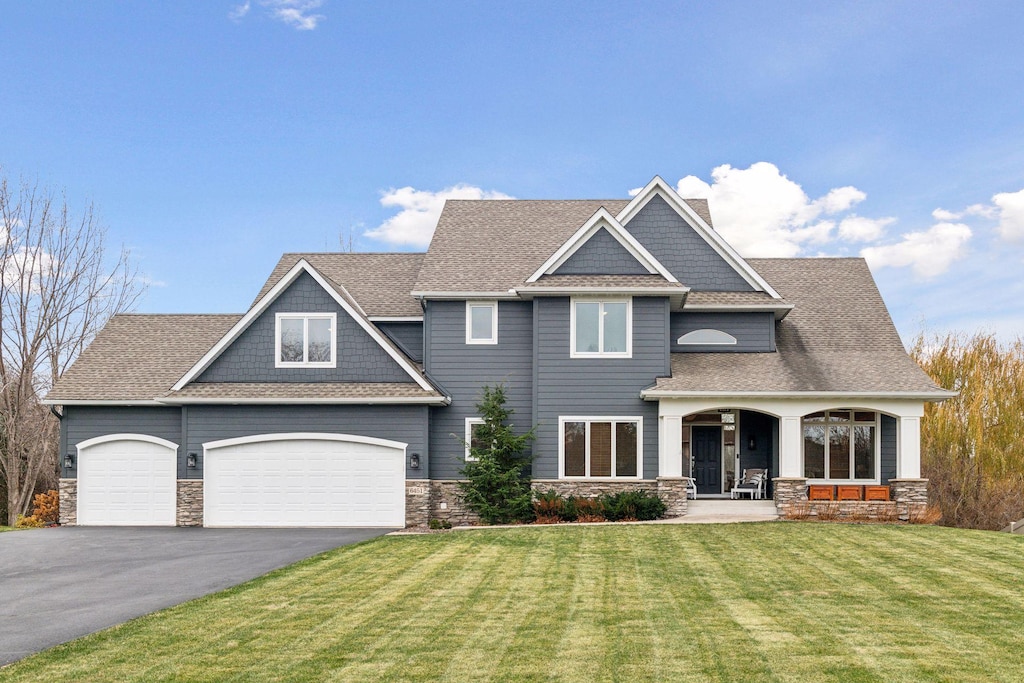 6451 Pipewood Curv, Chanhassen, MN 55331 - craftsman inspired home featuring covered porch, a front yard, and a garage