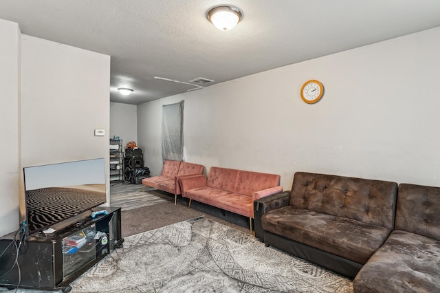 living room featuring a textured ceiling and carpet floors