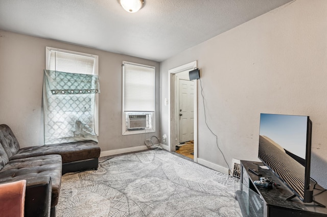 sitting room with cooling unit and a textured ceiling