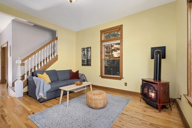 living room featuring a wood stove and light hardwood / wood-style flooring